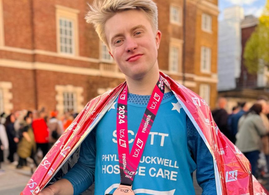 A marathon runner with his medal around his neck