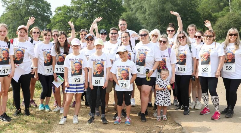 Participants waving as they start a fundraising walk