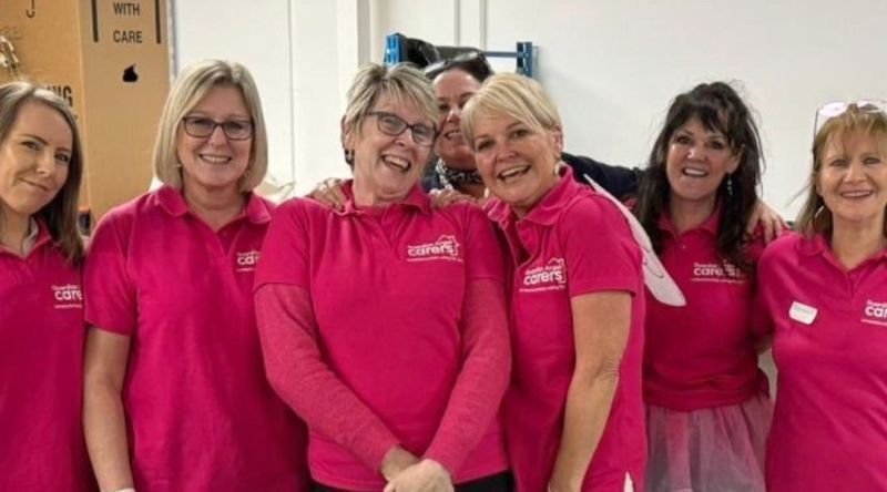 A team of corporate supporters smiling at the camera
