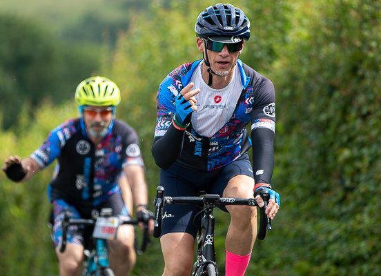 Two cyclists waving to the camera