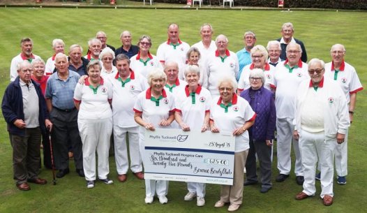 A bowls club presenting a donation cheque