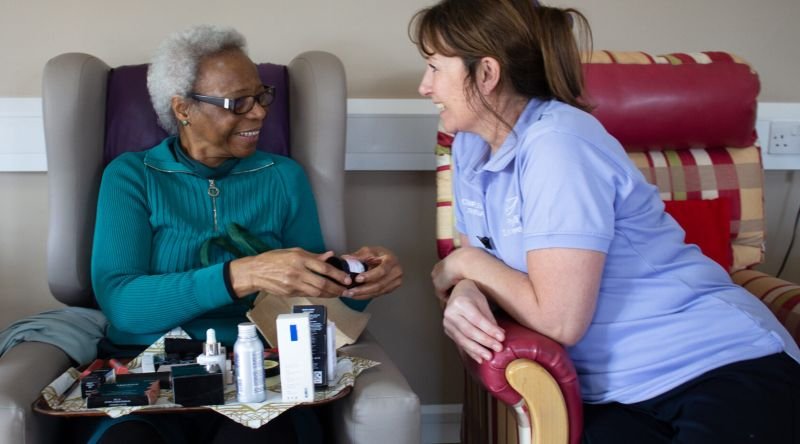 A Phyllis Tuckwell Complementary Therapist with a patient