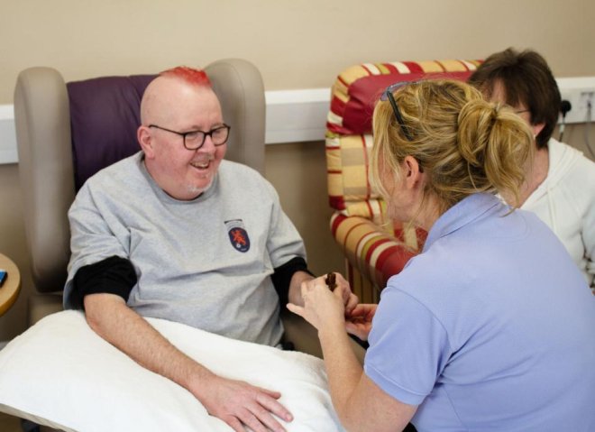 Aromatherapist massaging the hands of a patient