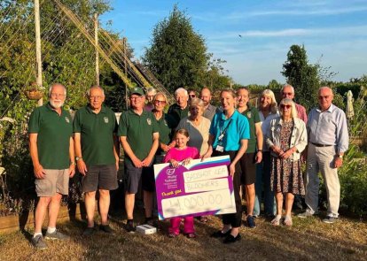 Some people holding a large cheque