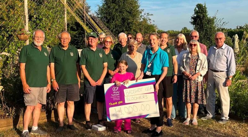 Some people holding a large cheque