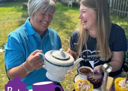 Two people with tea and cakes
