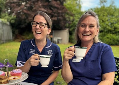 Two nurses enjoying tea and cakes