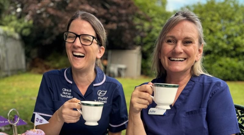 Two nurses enjoying tea and cakes