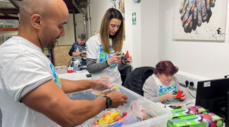 Corporate supporters sorting stock at a table