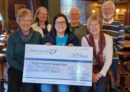 People holding a big cheque