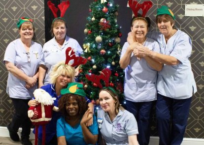 Nurses and health care assistants by Christmas tree