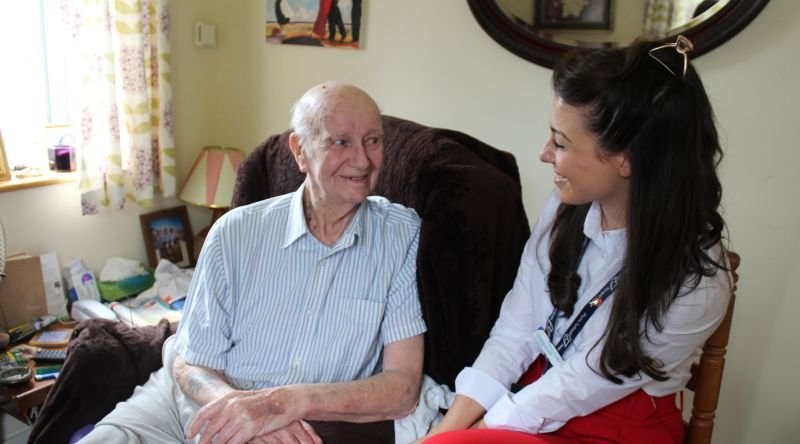 Patient and clinical nurse specialist smiling at each other
