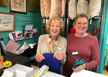 Two volunteers in a shop