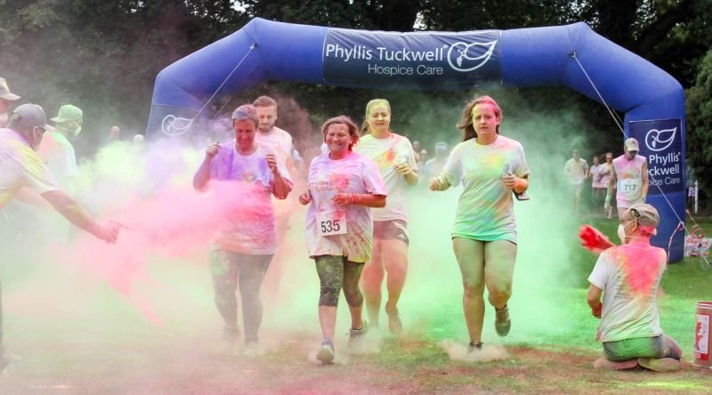 People running in colourful fun run