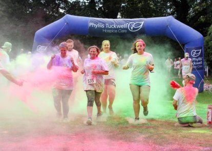 People running in a colourful fun run