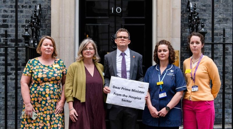 People standing in front of 10 Downing Street