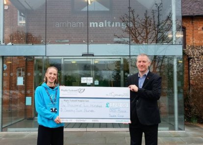 Two people holding a big cheque