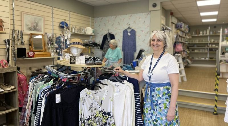 Lady in shop smiling at camera