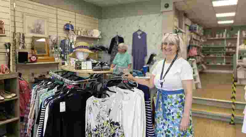 Lady in shop smiling at camera