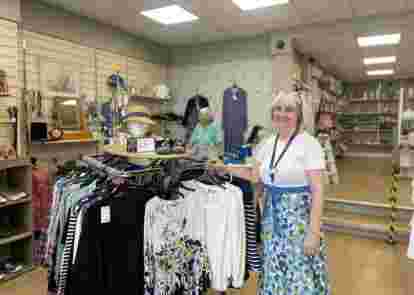 Lady in shop smiling at camera