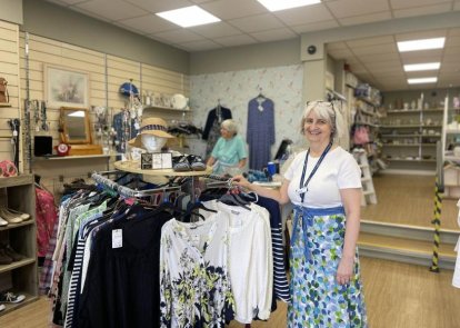 Lady in shop smiling at camera