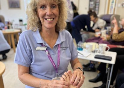 A volunteer complementary therapist giving a foot massage