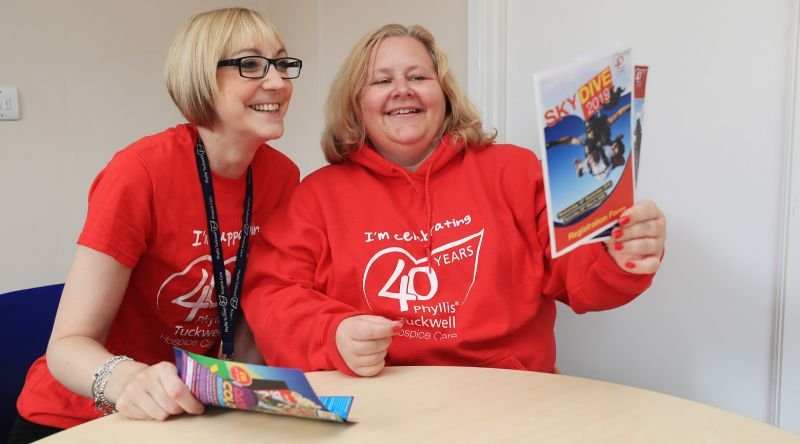 Fundraisers smiling looking at leaflets