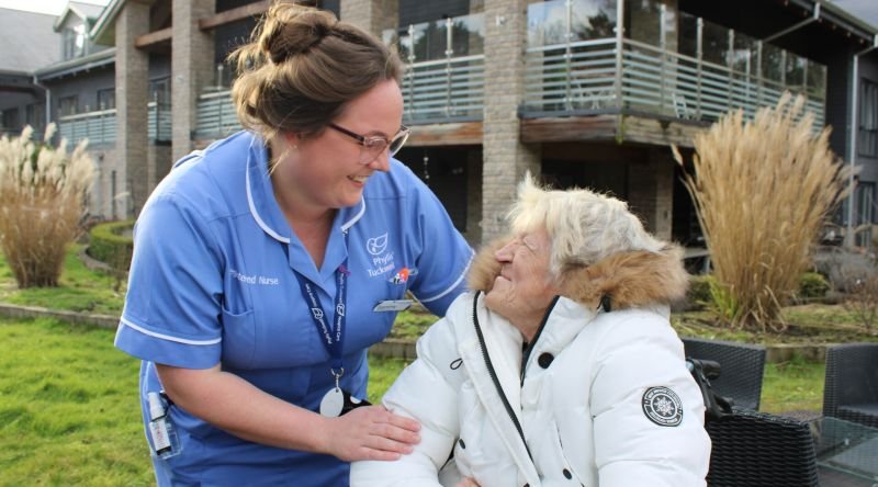 A nurse smiling with a patient