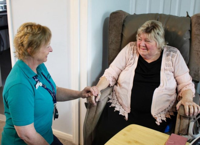 Occupational therapist holding hands with a patient