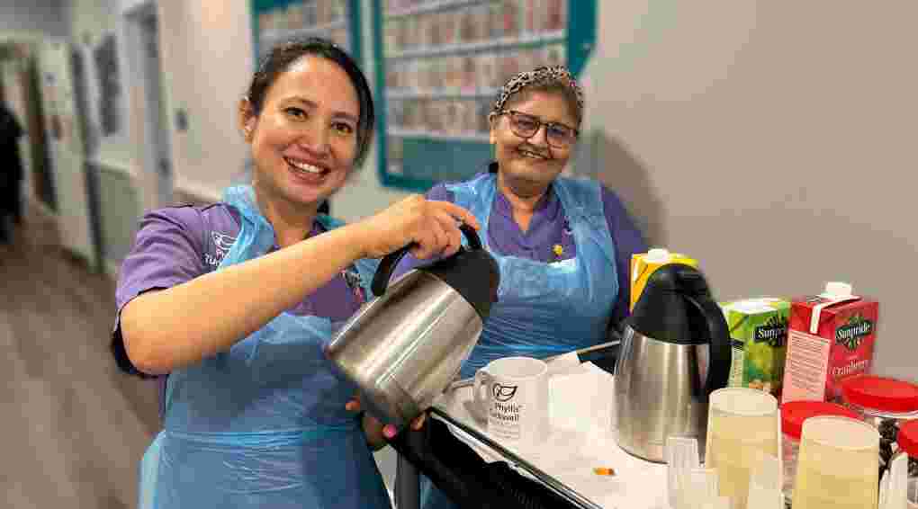 Two housekeepers making a cup of tea
