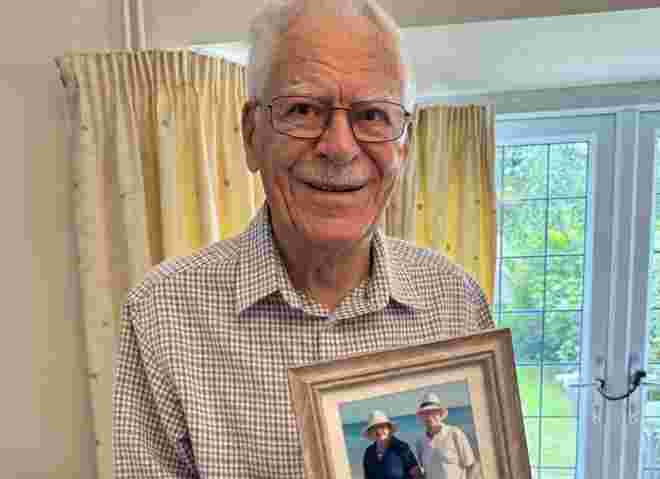 Jim holding photo of him and Stephanie