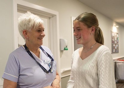 Nurse with student volunteer