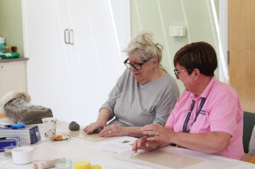 Patient and rehabilitation assistant at mindfulness with clay