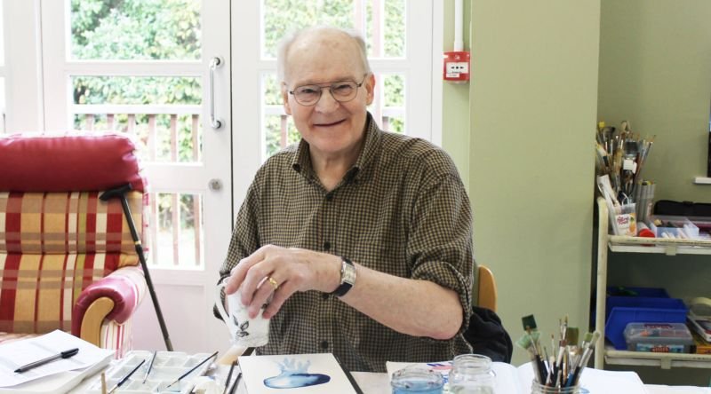 Patient smiling at art group