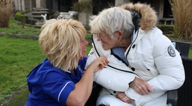 Nurse and patient smiling at each other