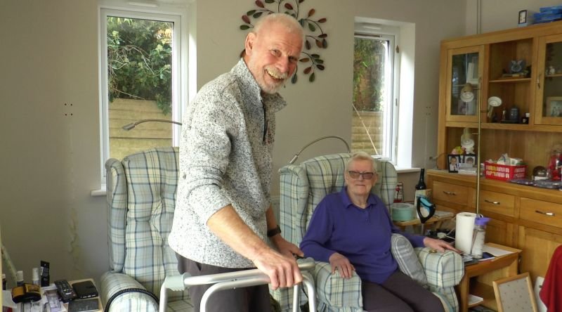 Smiling carer and patient at home