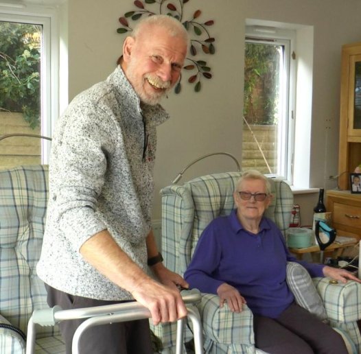Smiling carer with patient at home