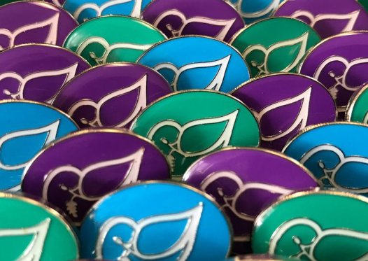 A display of colourful Phyllis Tuckwell pin badges