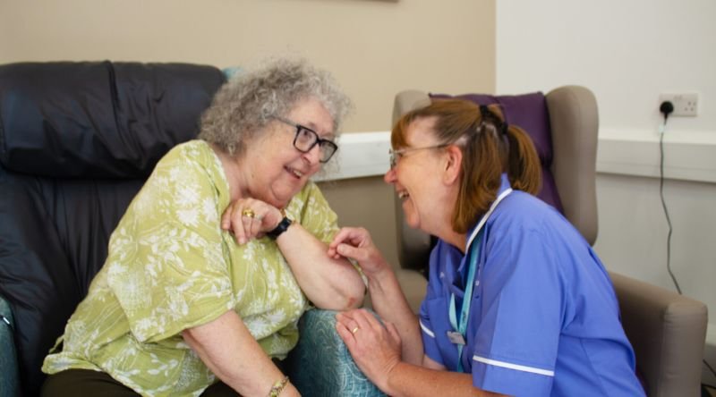 Patient and nurse smiling at each other
