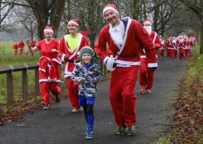 People running dressed as Santa