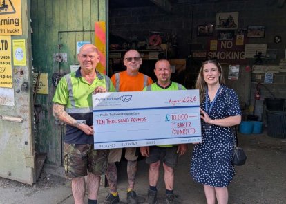 Four people with a big cheque