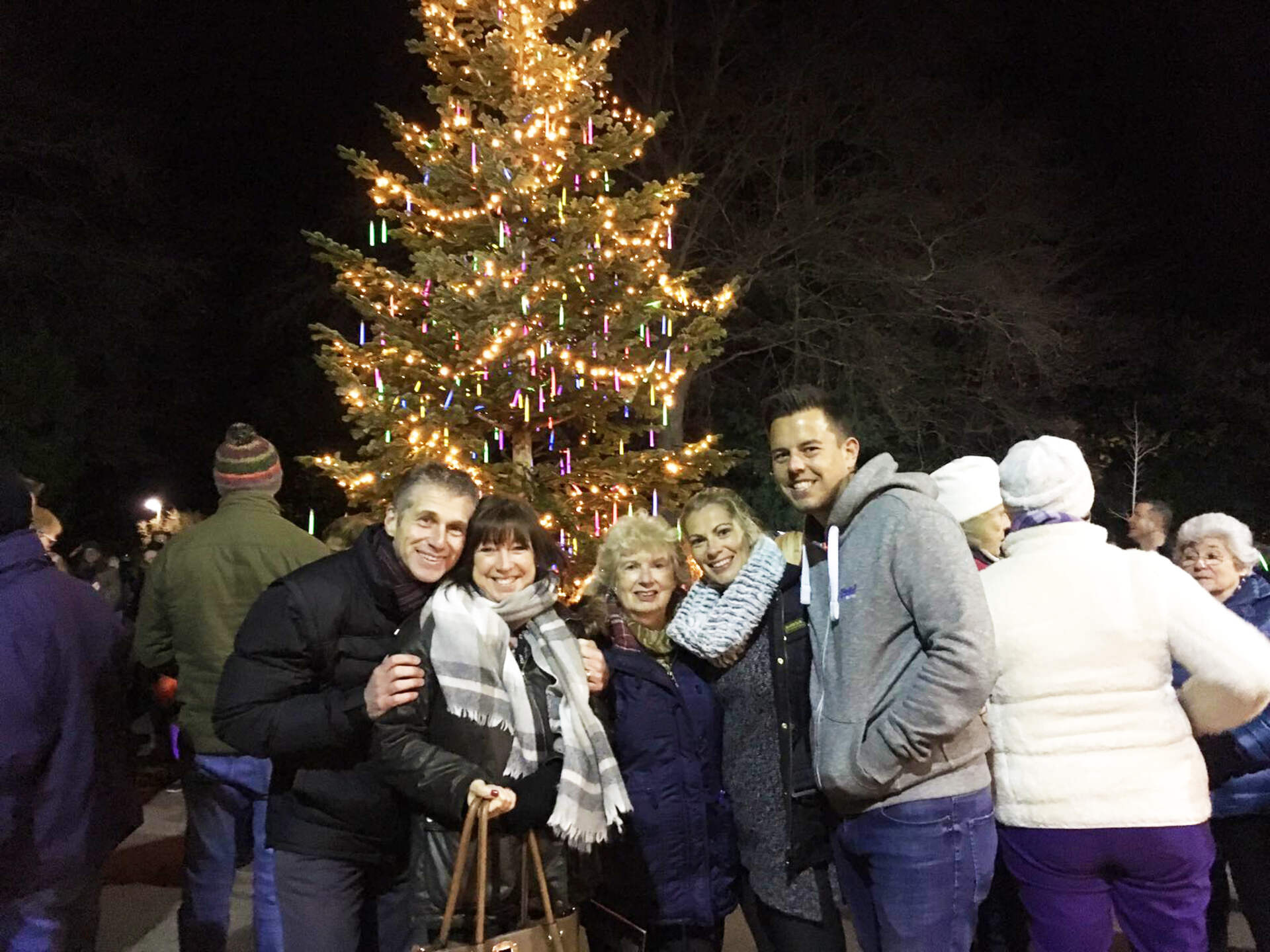 A family in front of a Christmas tree