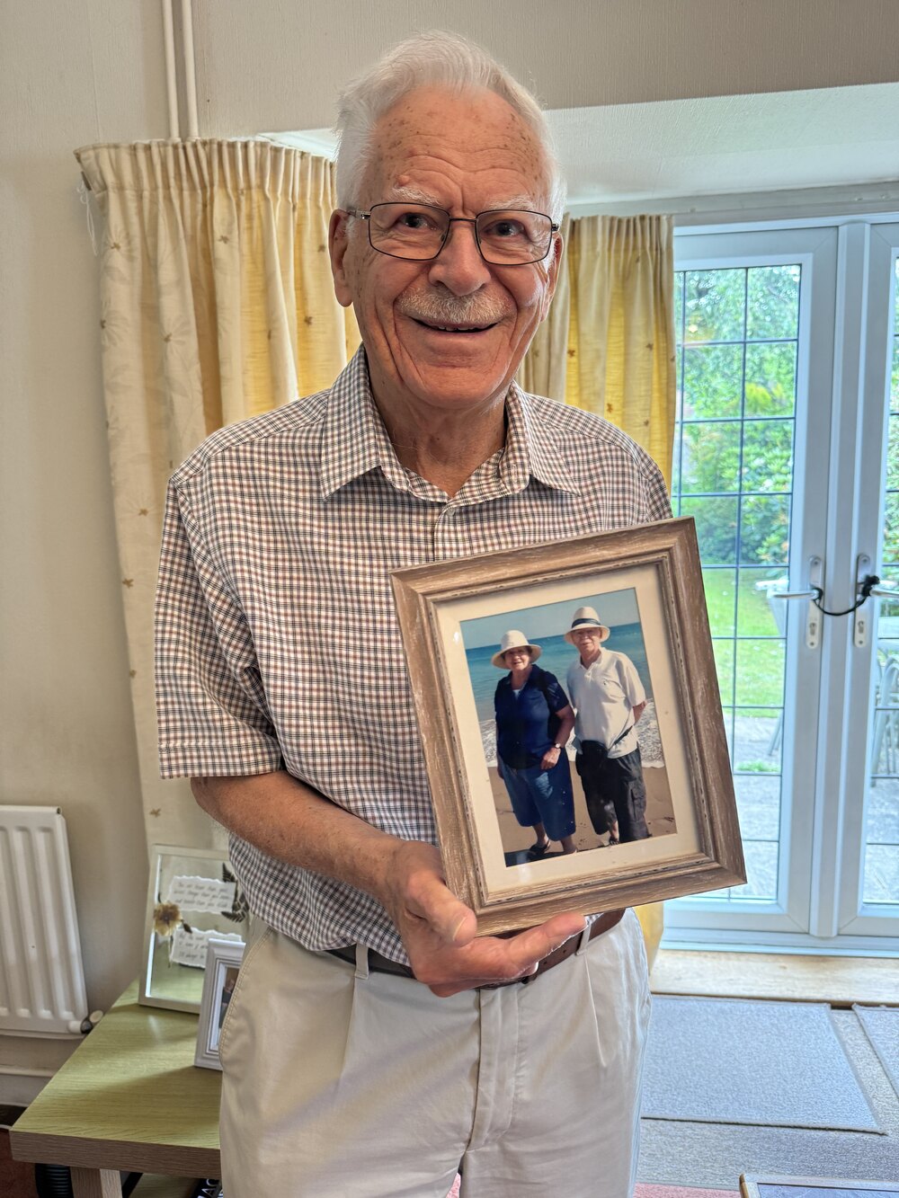 Jim holding photo of him and Stephanie