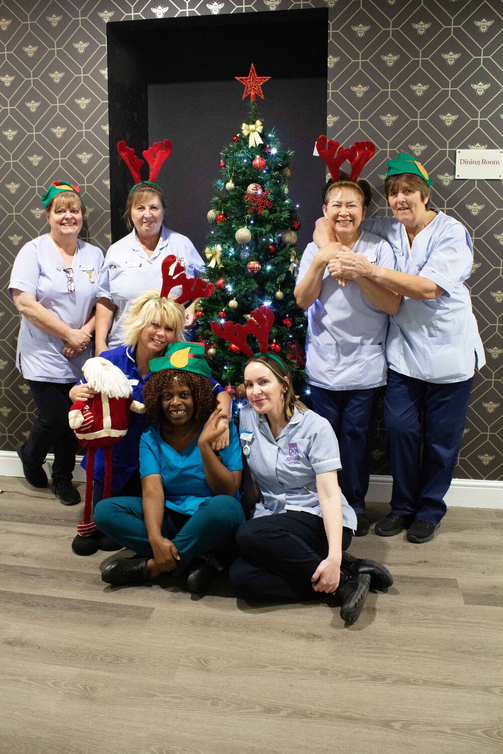 Nurses and health care assistants by Christmas tree