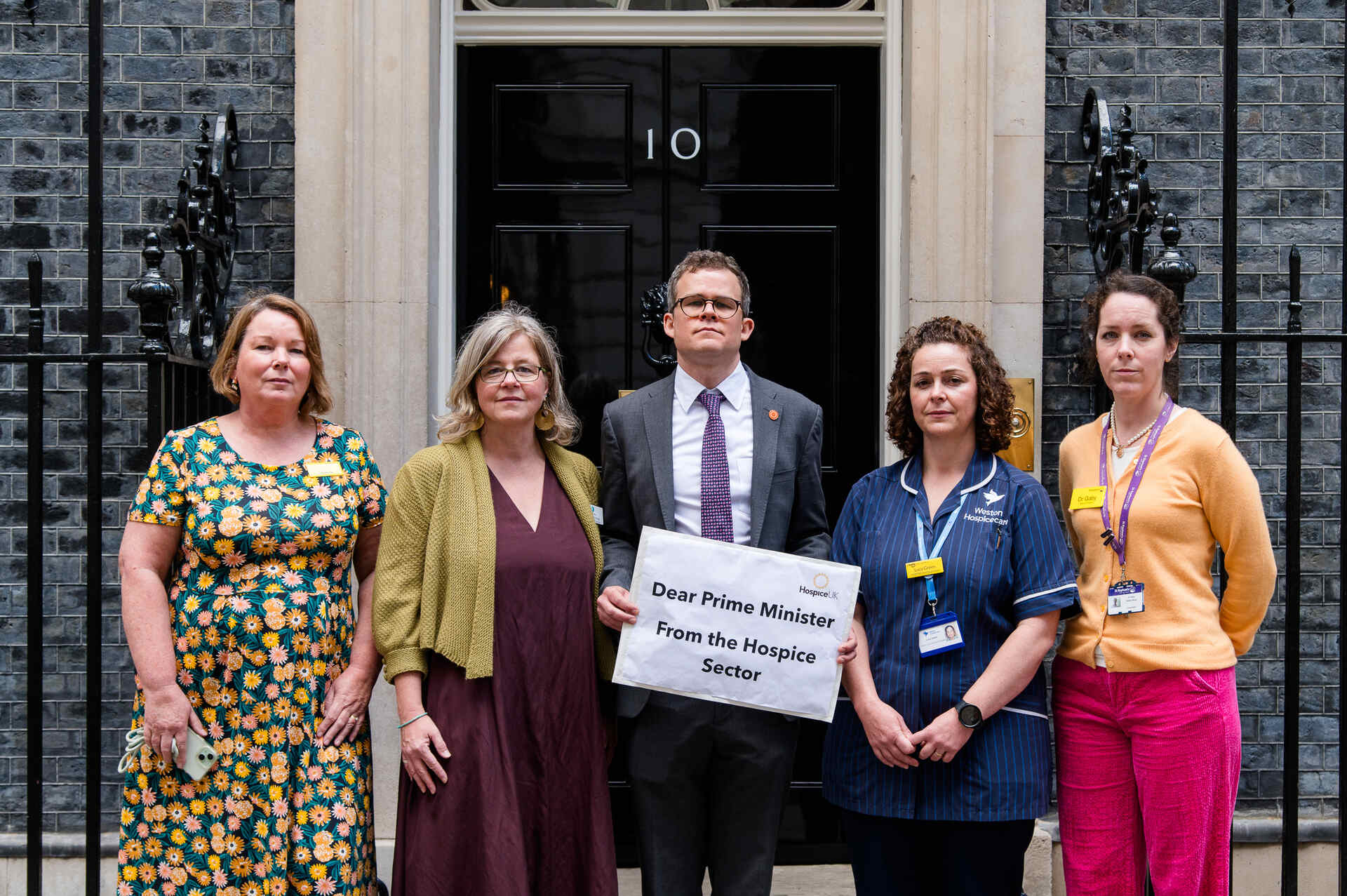 People standing in front of 10 Downing Street